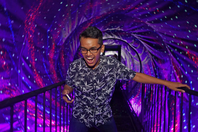 dubai museum of illusions man walking through vortex tunnel