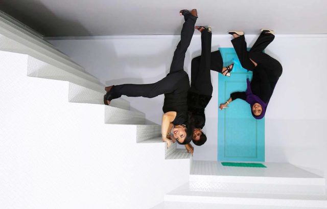 visitors at dubai museum of illusions upside down